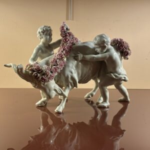 Porcelain group: Putti adorning a goat with flowers, 19th Century