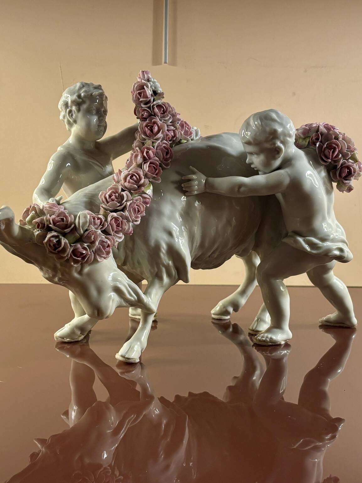 Porcelain group: Putti adorning a goat with flowers, 19th Century
