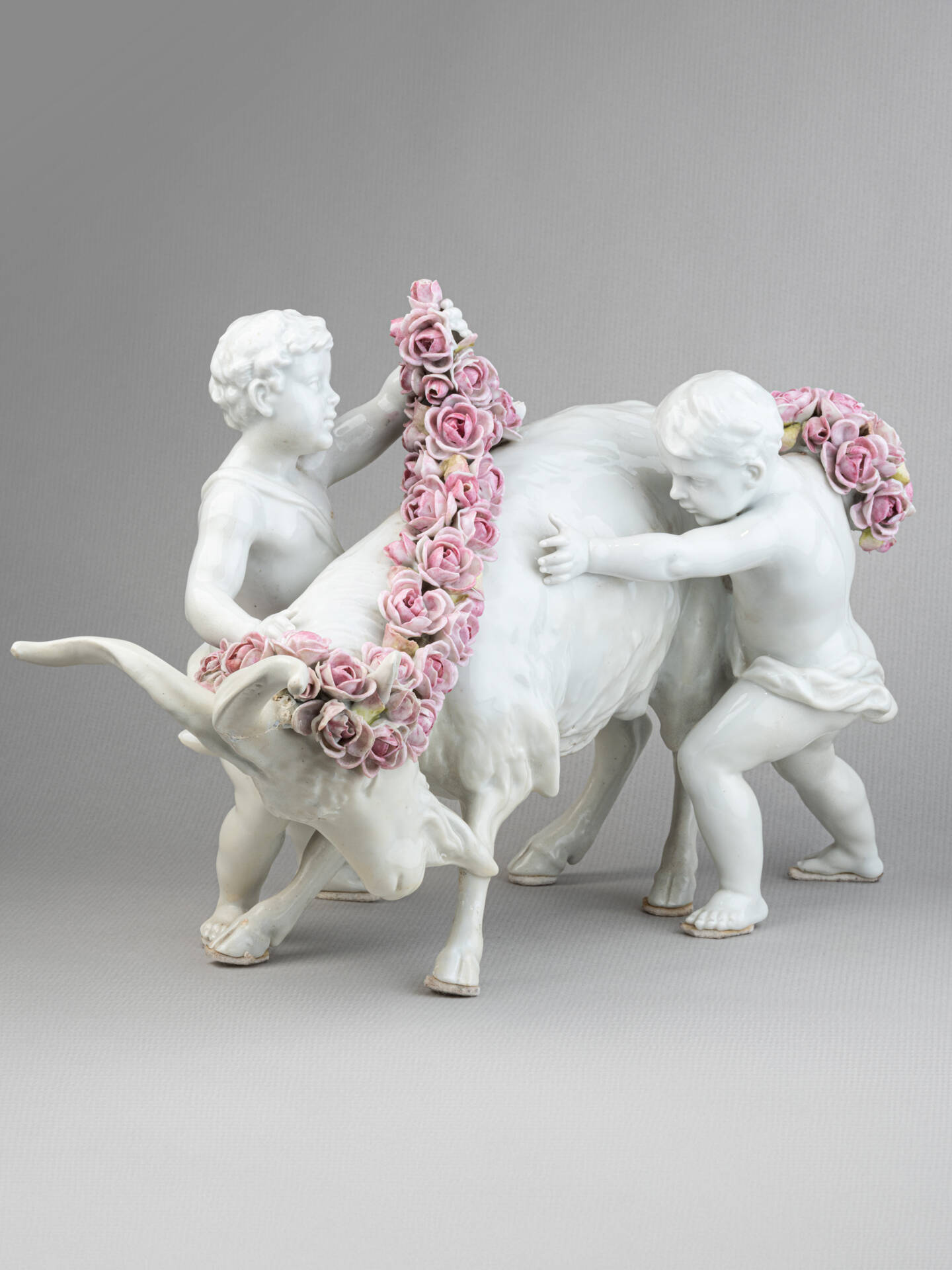 Porcelain group: Putti adorning a goat with flowers, 19th Century