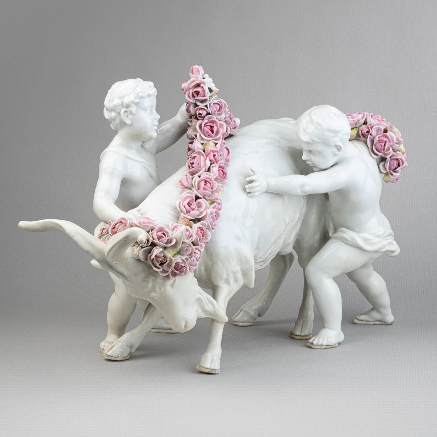 Porcelain group: Putti adorning a goat with flowers, 19th Century